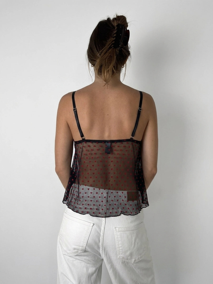 Back view of sheer red polka dot camisole with adjustable straps.