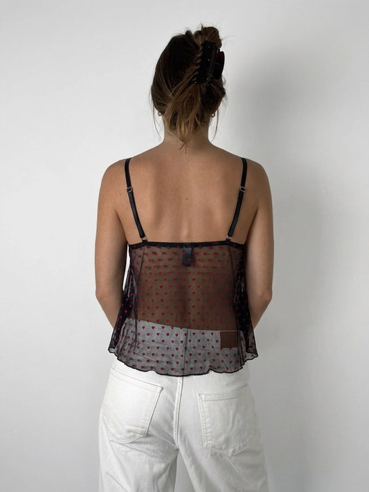 Back view of sheer red polka dot camisole with adjustable straps.