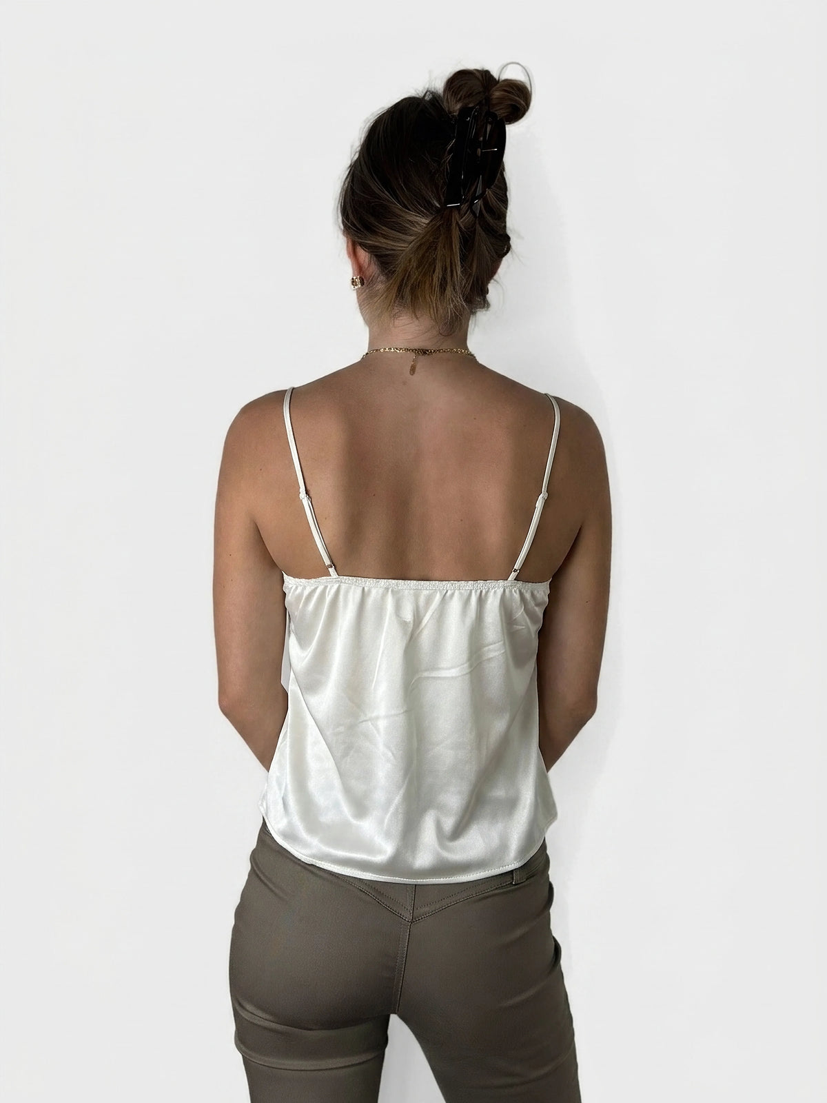 Back view of sheer white lace cami top with delicate straps.