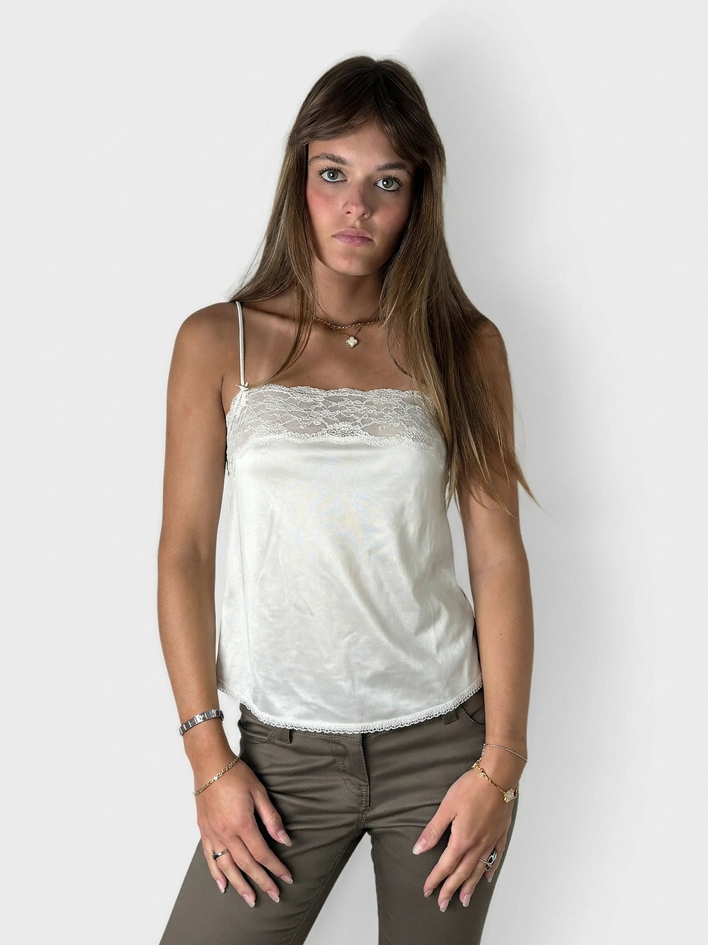 Sheer white lace cami top with delicate trim, front view.