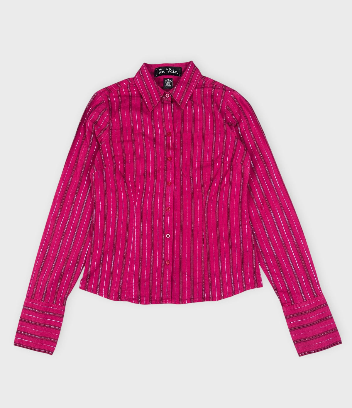 Detail view of a long sleeve pink shirt with silver vertical stripes.