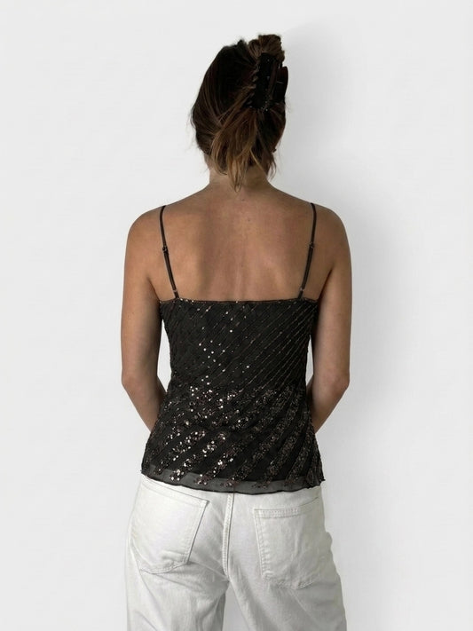 Back view of shiny black cami top with glitter detail and diagonal pattern.