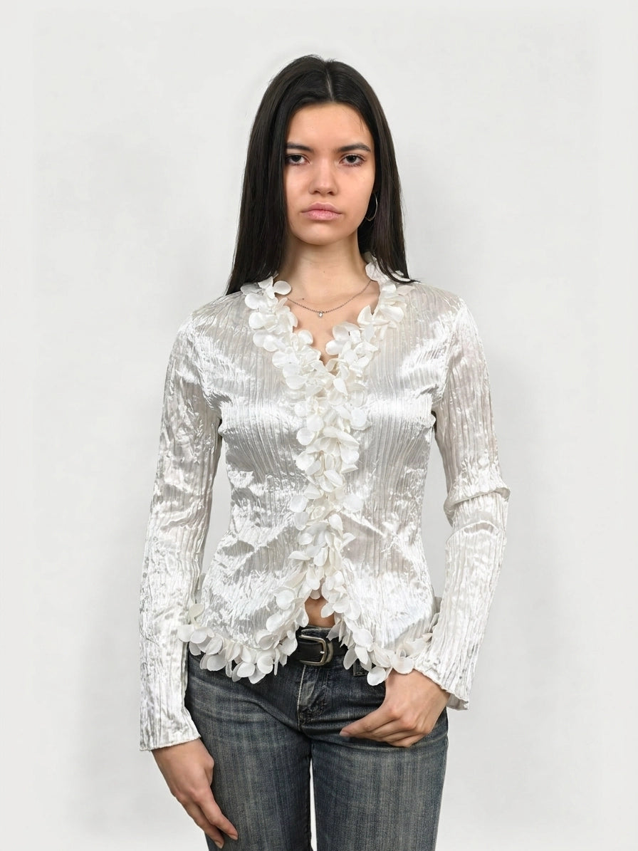 Shiny long sleeve blouse in silver with floral trim, front view.