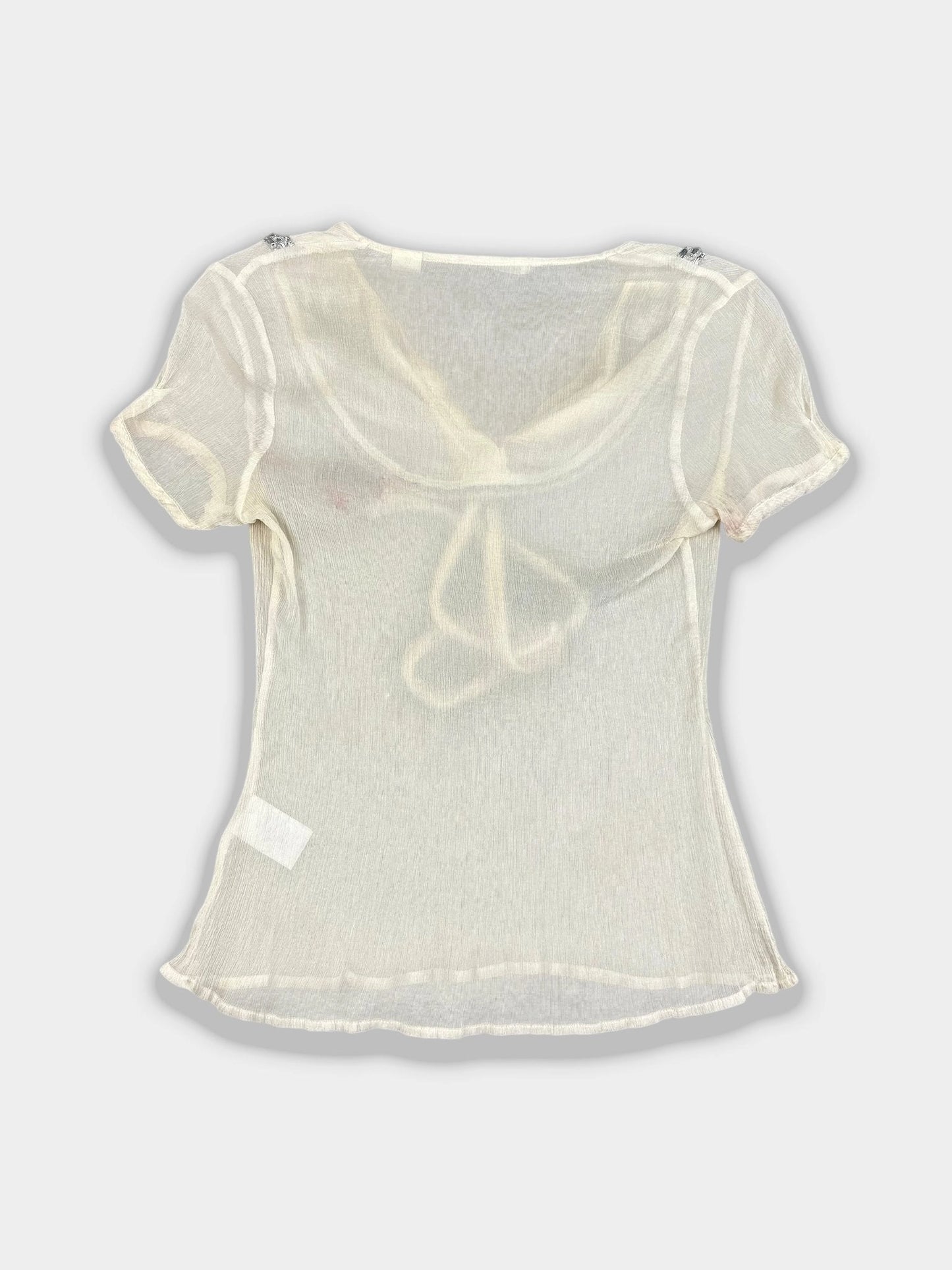 Back view of a silk tie-front top in cream with a tie detail.