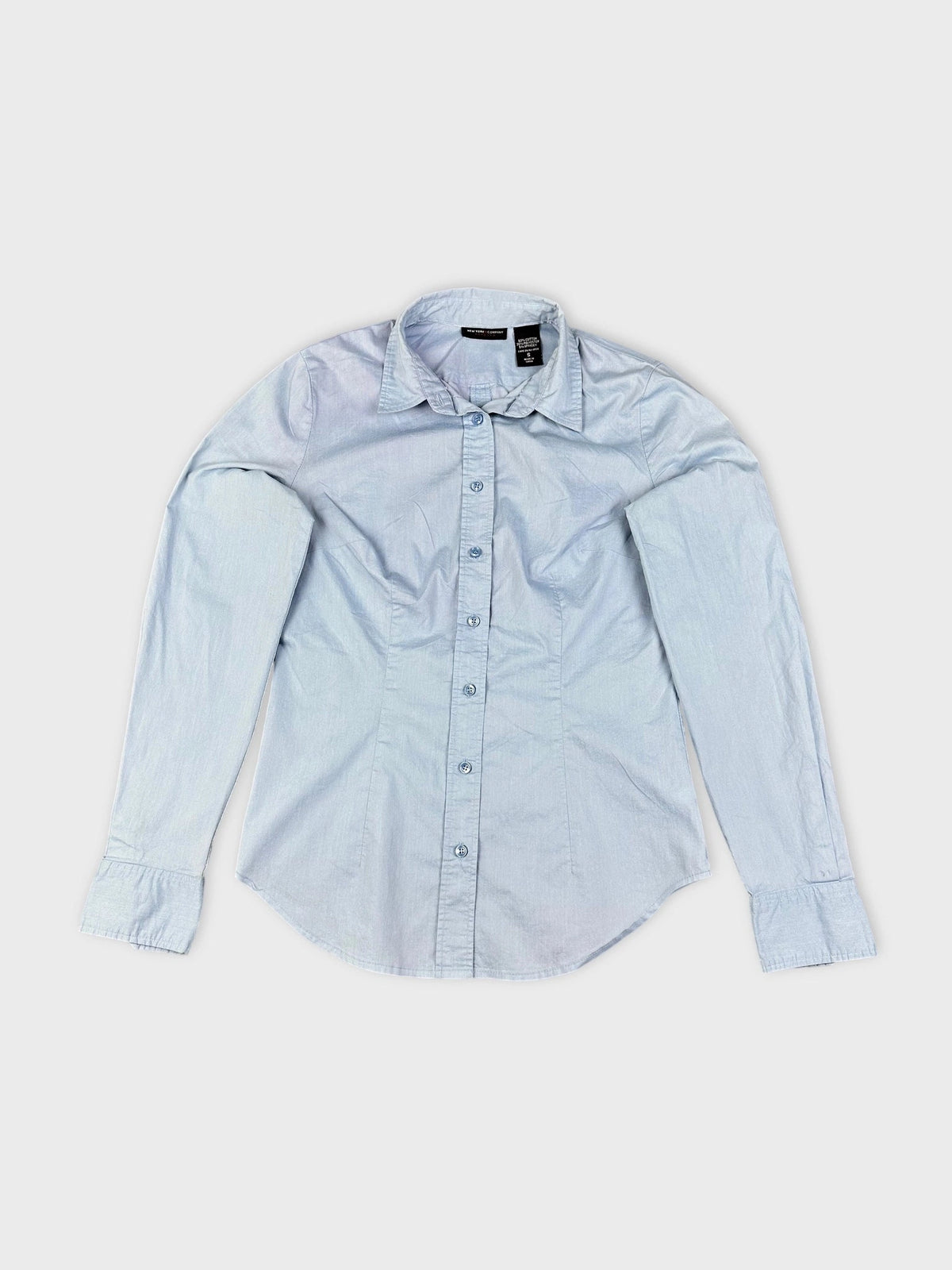 Sky blue button up shirt with a button detail view