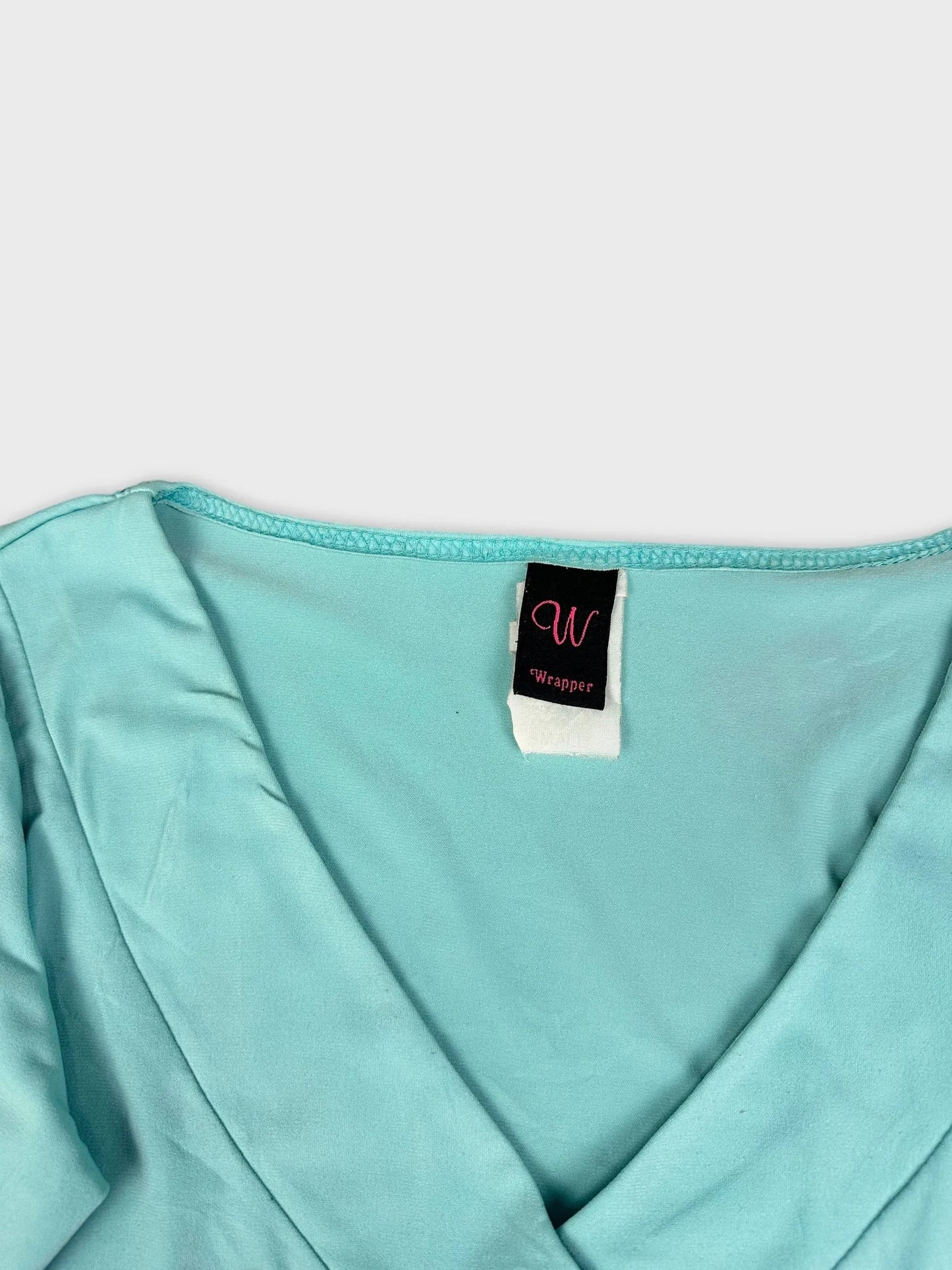 Sky blue long sleeve top with V-neck detail view showing neckline and label.