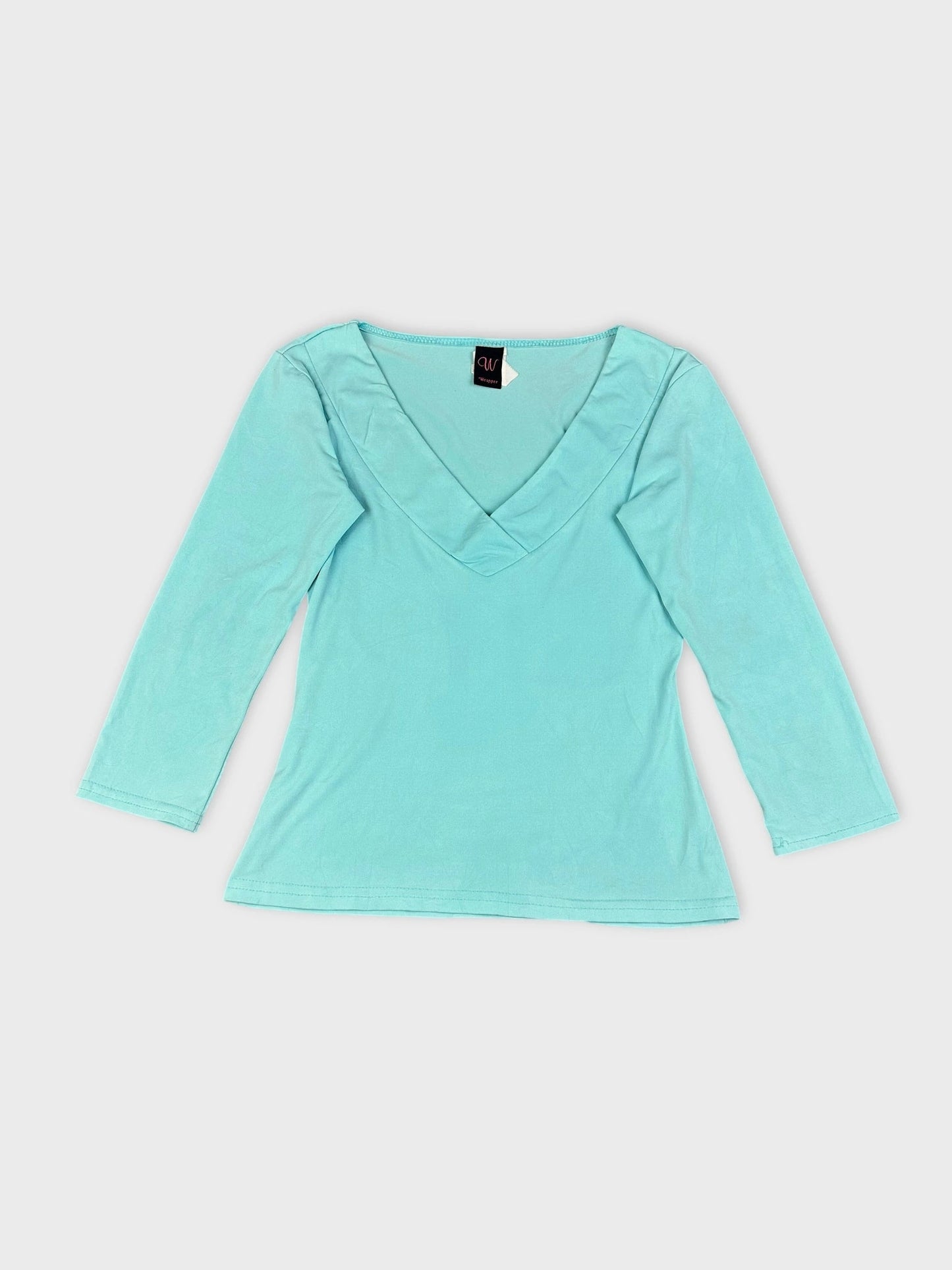 Sky blue long sleeve top detail view with V-neck design.
