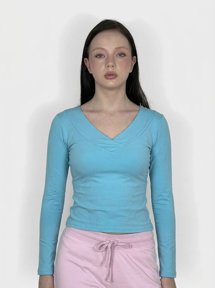 Sky blue long sleeve top with V-neck, front view, featuring a smooth finish.