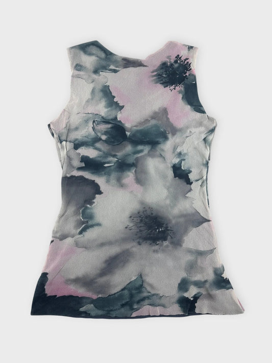 Back view of a sleeveless floral dress in shades of blue and pink.