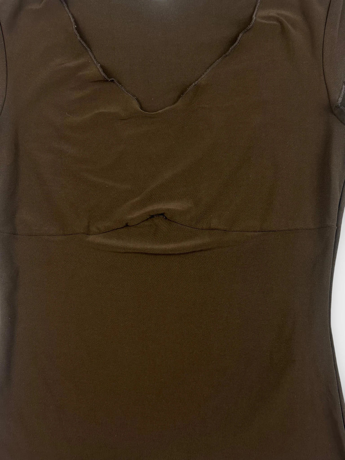 Detail view of a brown crop top with a v-neckline.