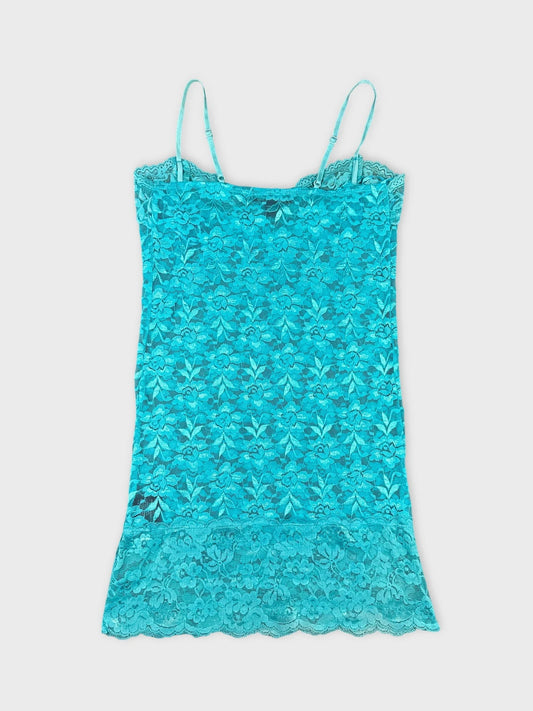 Turquoise lace top with delicate straps back view showcasing floral pattern.