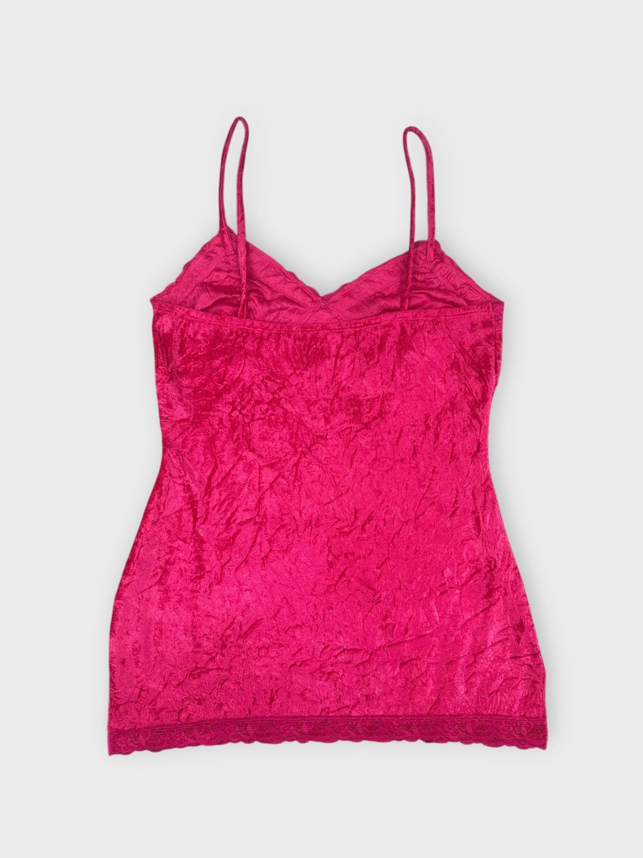 Back view of a vibrant fuchsia lace camisole with a scalloped trim.