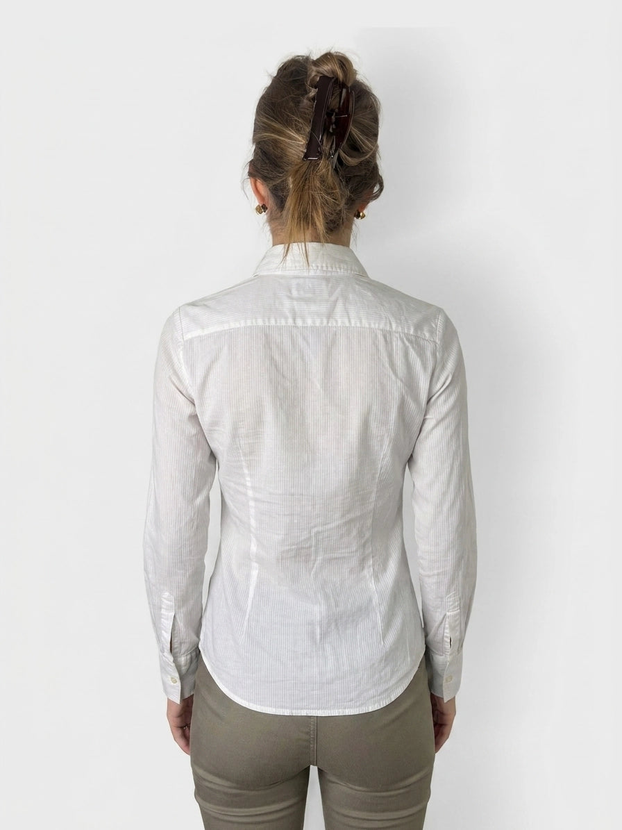 Back view of a white cotton button-up shirt with a collar.