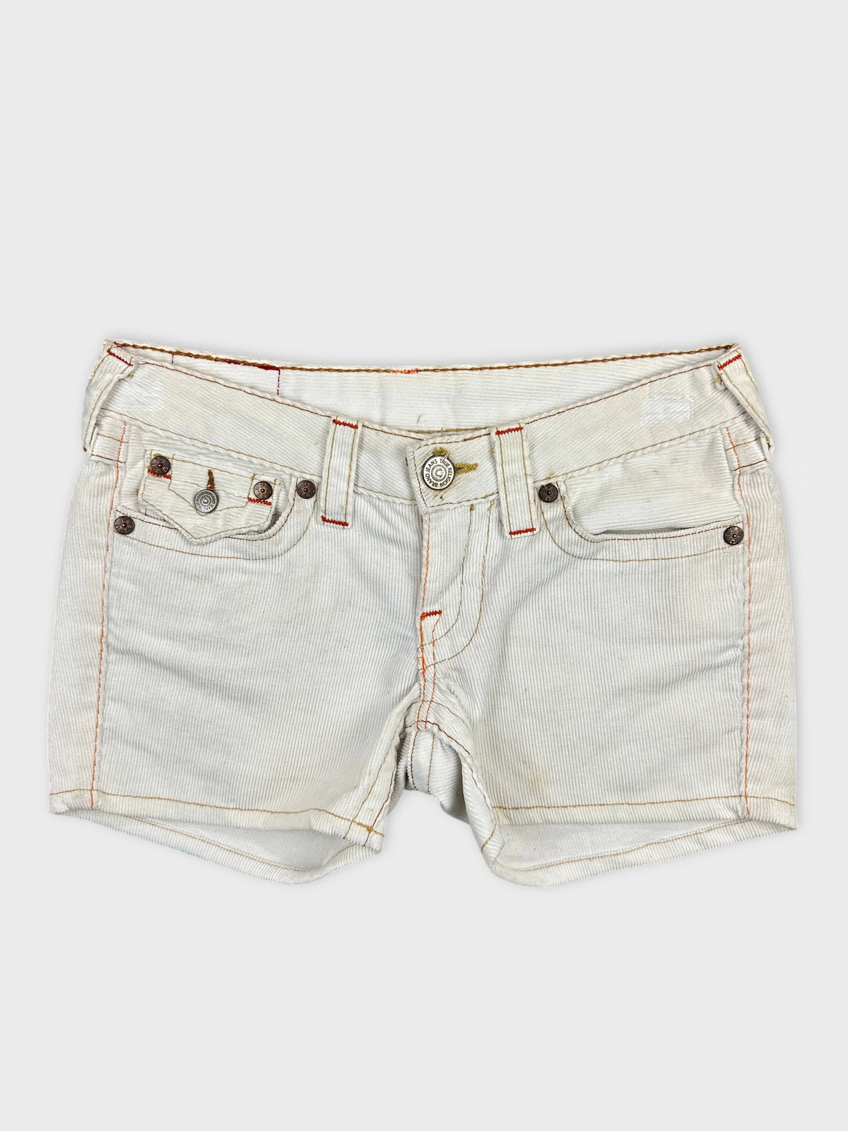 Front view of white denim shorts with edgy orange stitching details.