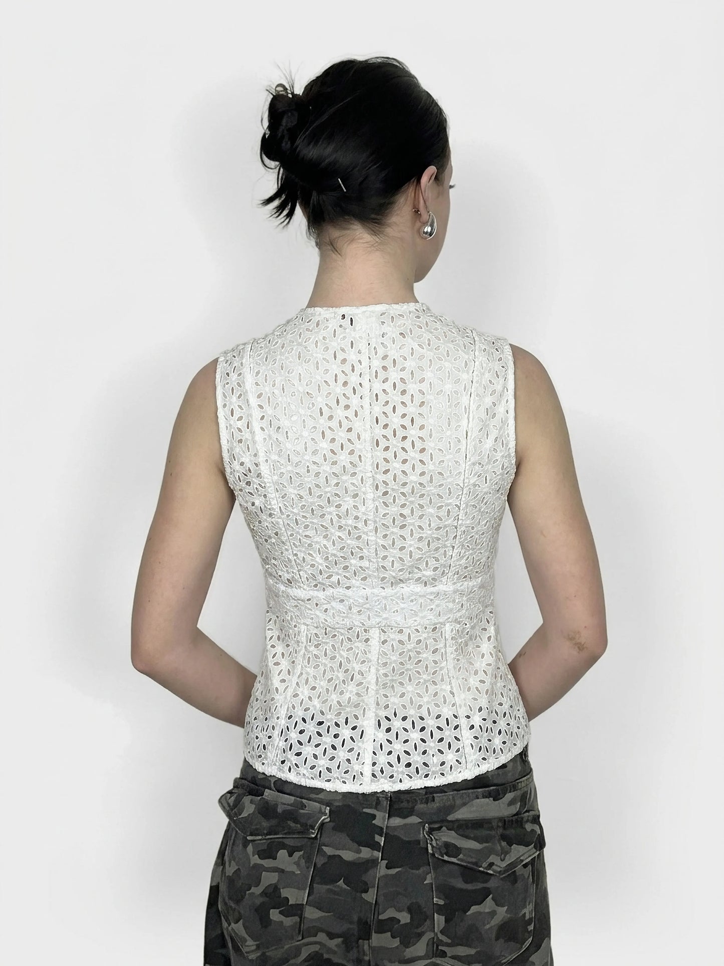 Back view of a white lace crop top featuring a V-neck design.