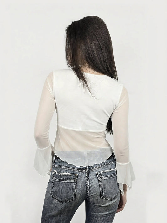 Back view of a white ruffled mesh top with elegant sleeves.