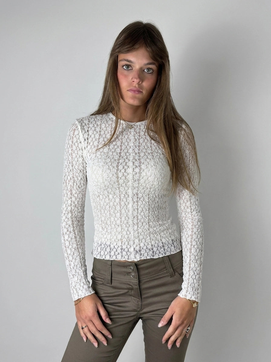 Front view of a white sheer long sleeve blouse with textured pattern.