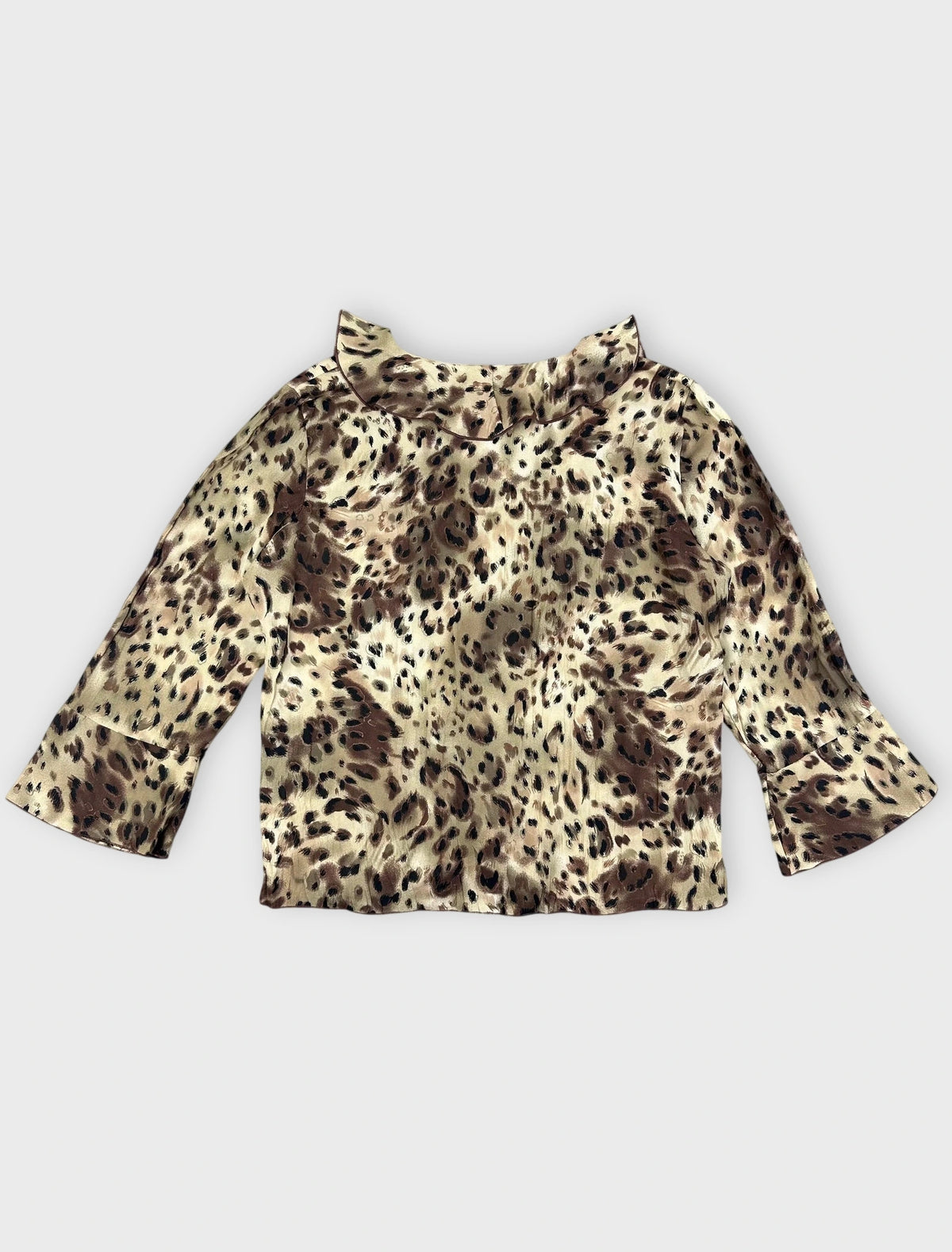 Back view of a wild print wrap top featuring beige and brown leopard pattern with ruffles.