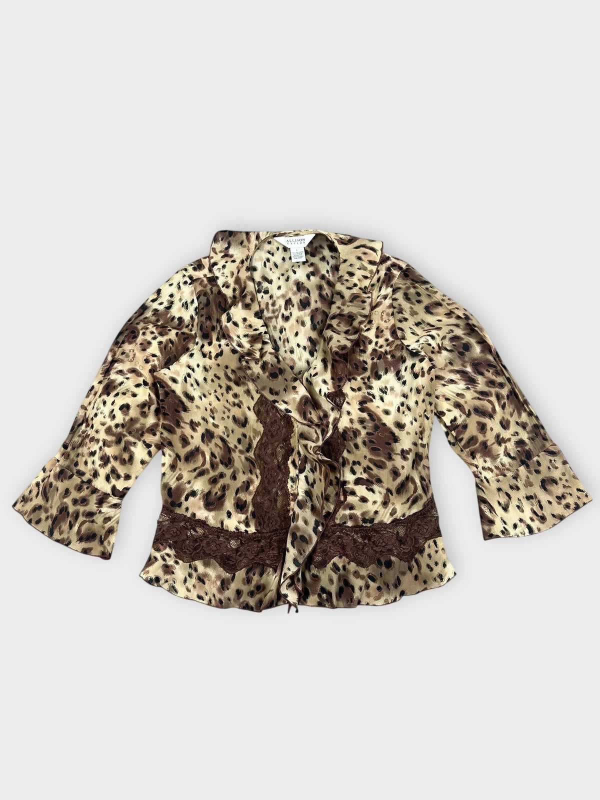 Front view of beige and brown wild print wrap top with ruffles.