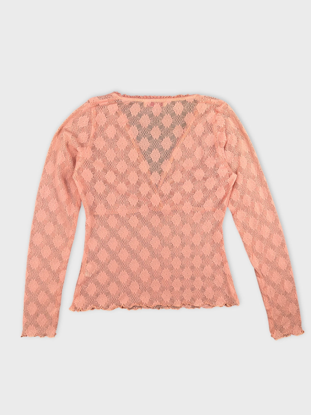 Back view of a pink lace long sleeve body shirt with scalloped hem.