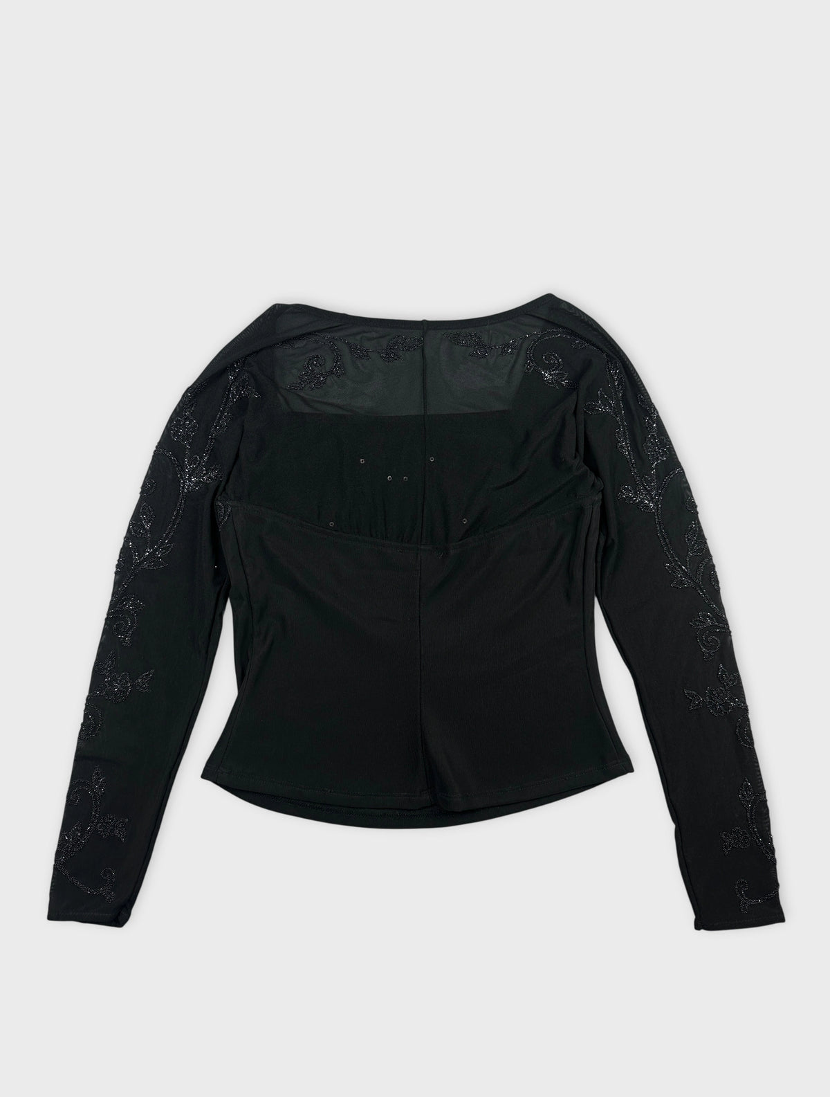 Back view of a black body shirt with floral embroidery on sleeves.