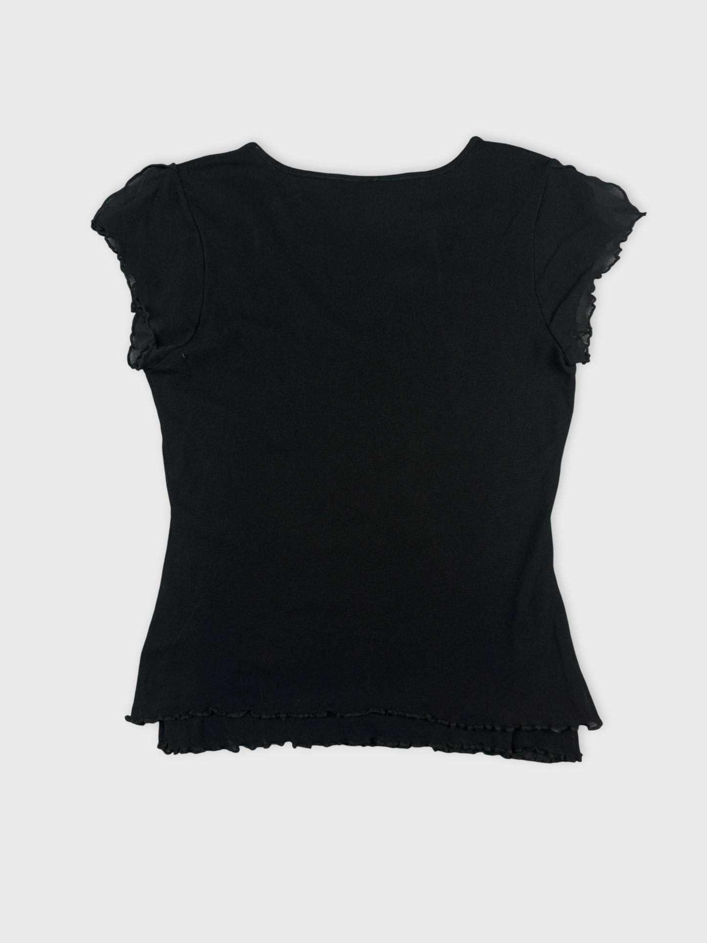 Back view of a black body shirt with ruffled sleeves.