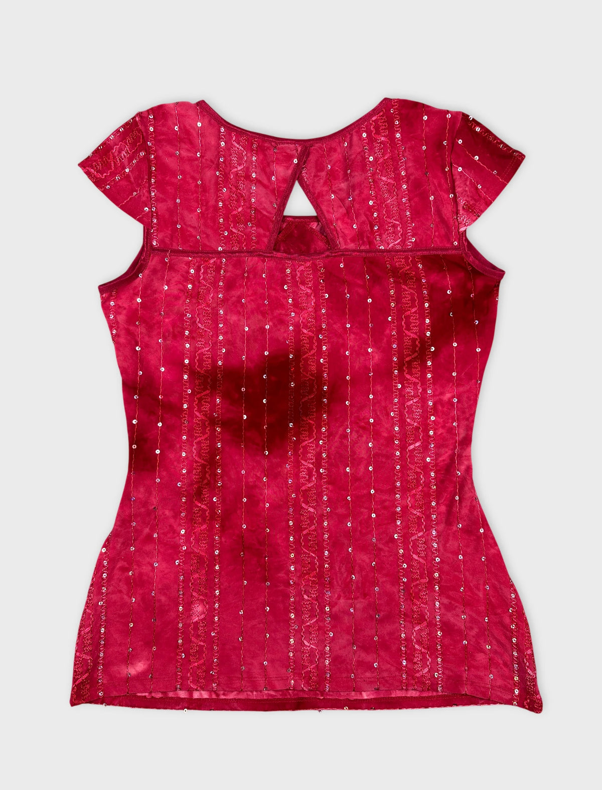 Back view of a pink body shirt with sparkling sequins and lace details.