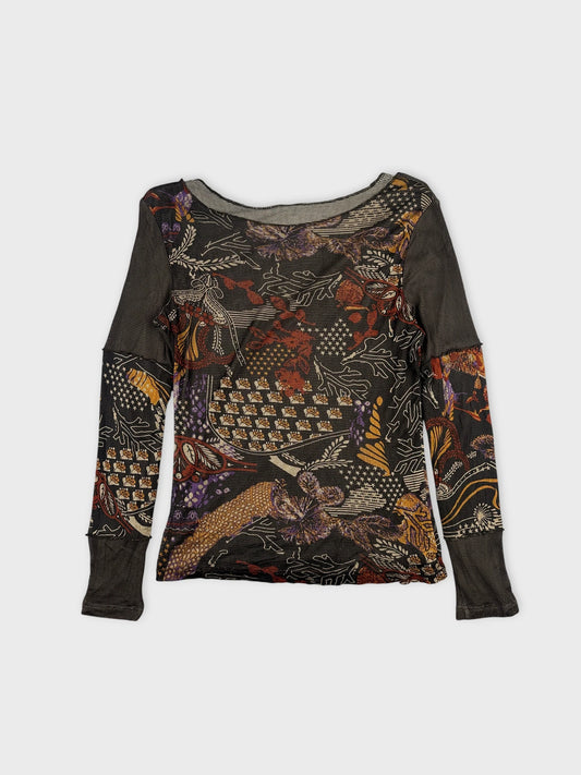 Detail view of a black long-sleeve body shirt with floral pattern.
