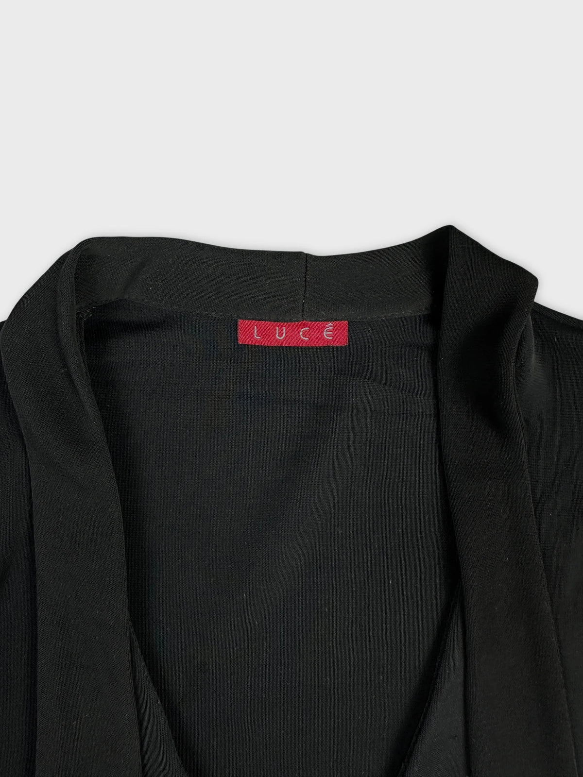 Black body shirt detail view showing neckline and fabric texture.