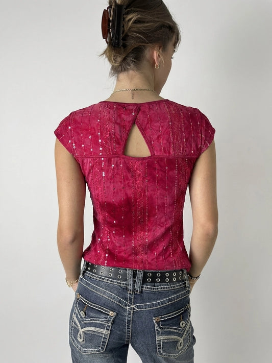 Back view of a pink body shirt featuring a keyhole detail.