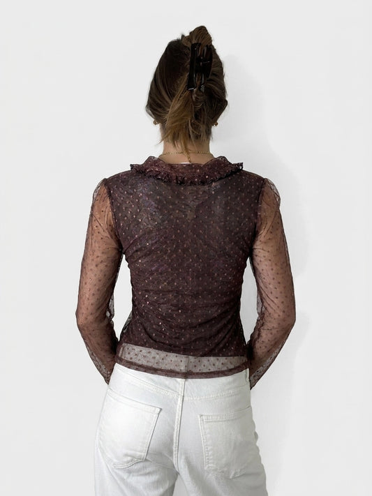 Back view of a burgundy women body shirt with ruffled neckline and dotted pattern.
