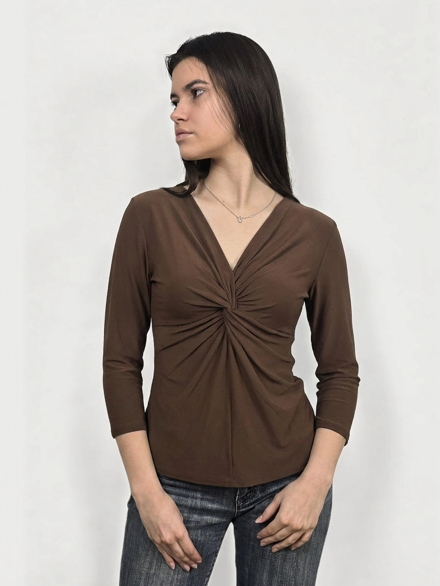 Front view of a women’s brown body shirt with a twisted detail.