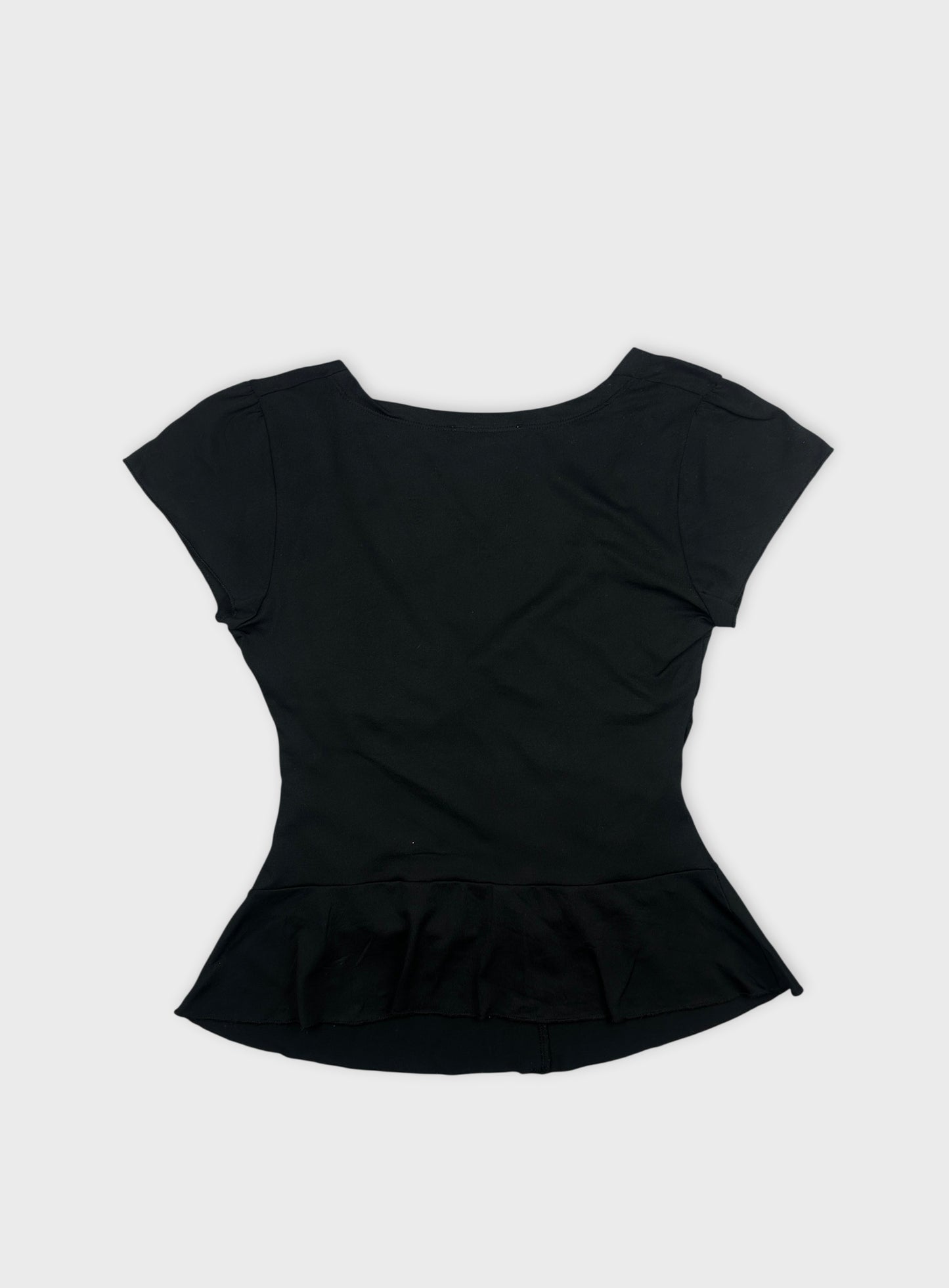 Back view of a black women’s body shirt with a flared peplum hem.