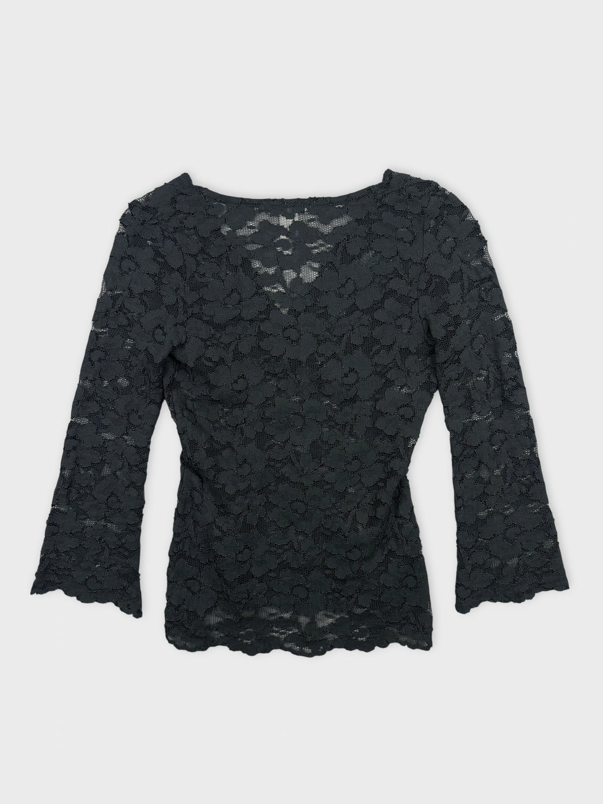 Back view of a black lace body shirt with floral pattern.