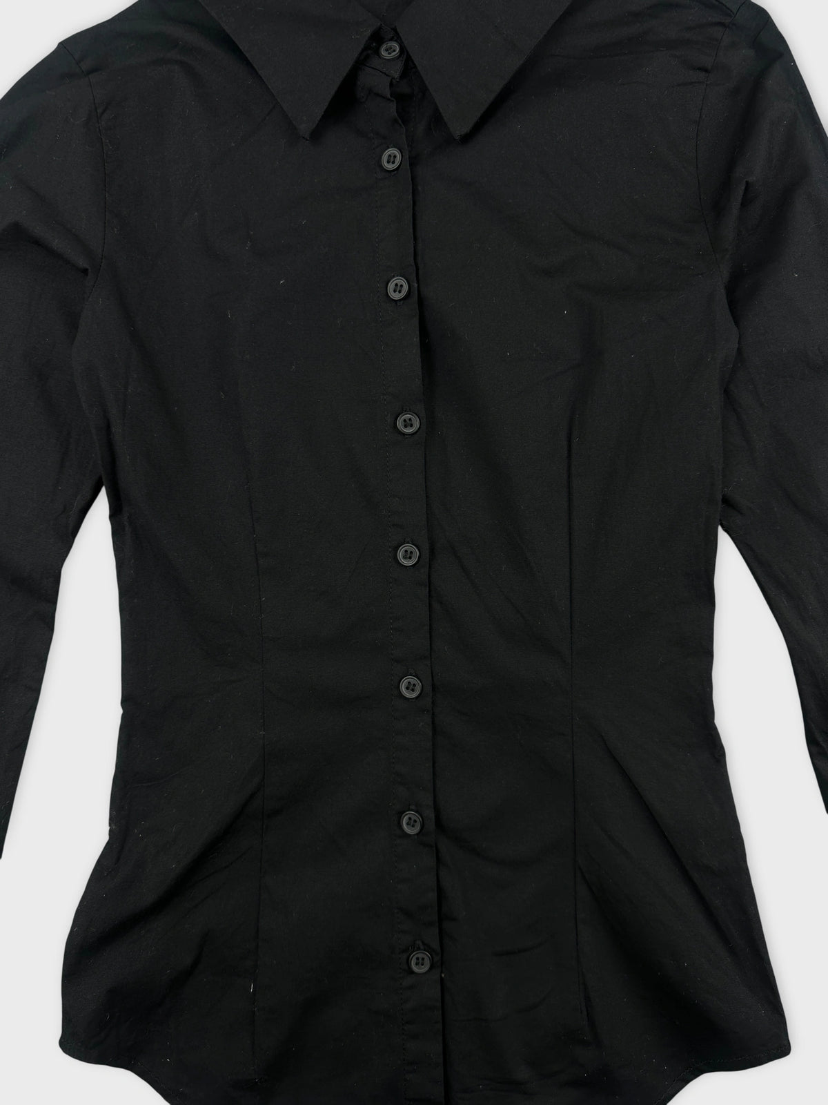 Women body shirt in black with button detail view.