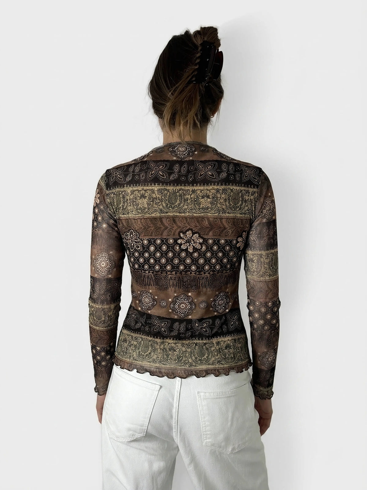 Back view of a brown long-sleeve shirt with intricate patterns and a scalloped hem.