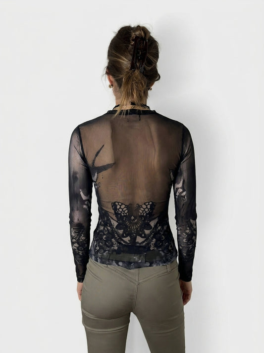 Back view of a black body shirt featuring a lace butterfly design.