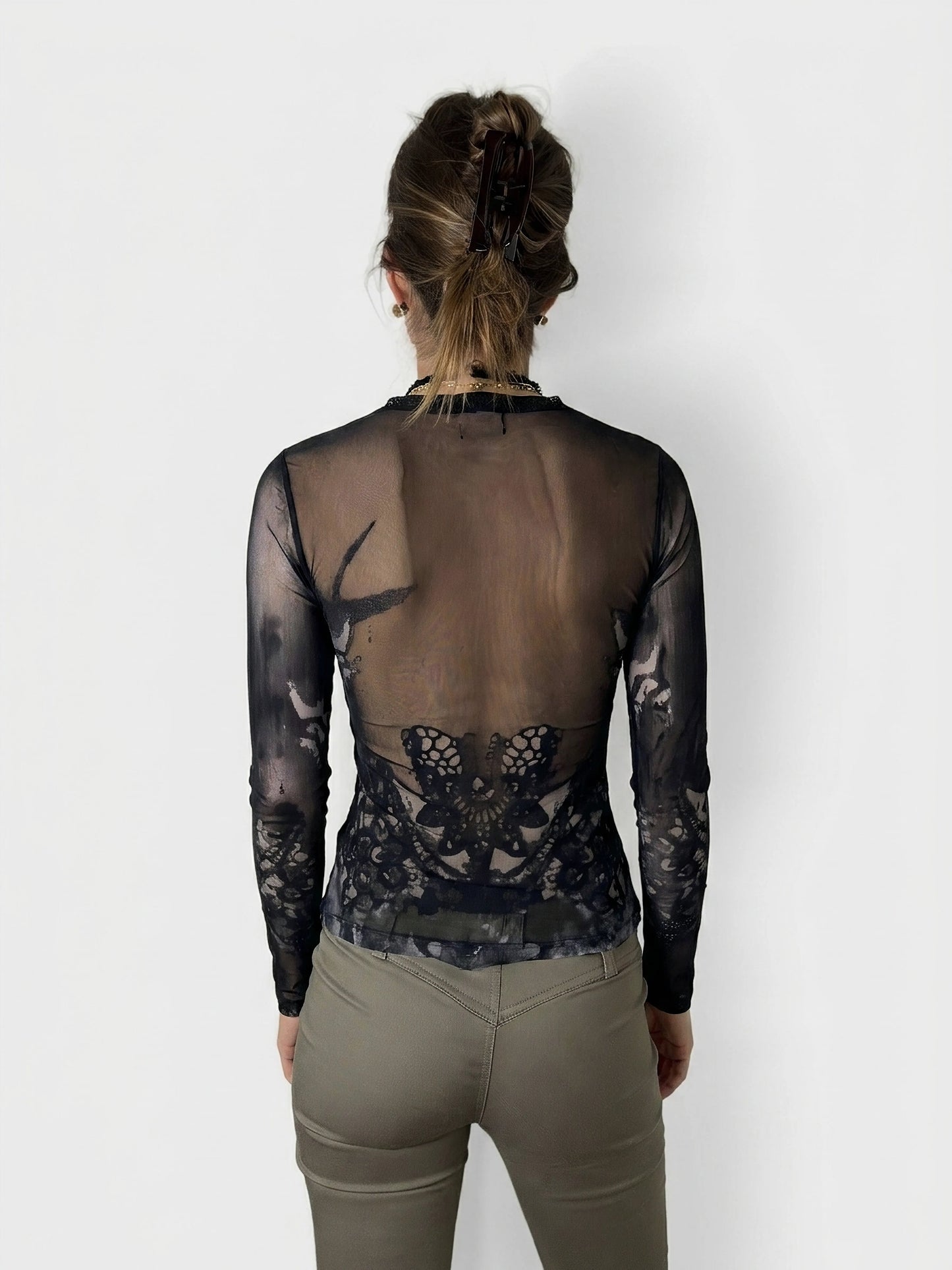Back view of a black body shirt featuring a lace butterfly design.