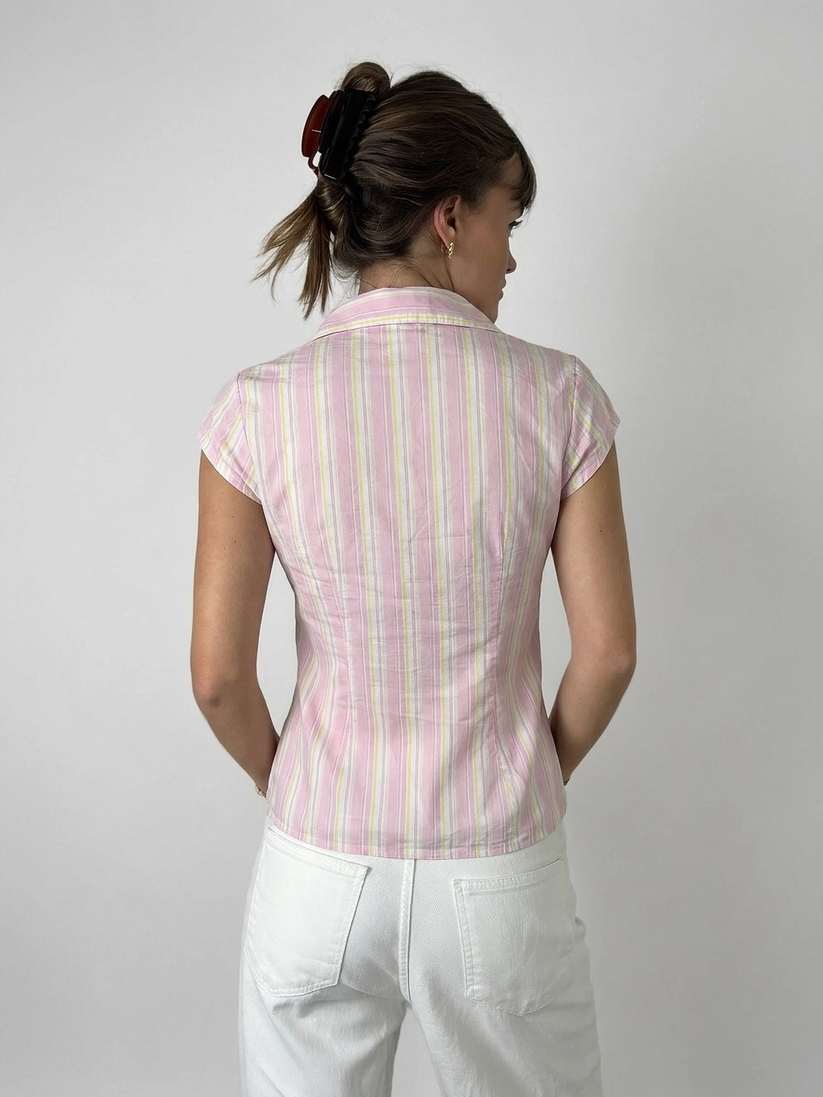 Back view of a pink striped body shirt with short sleeves.