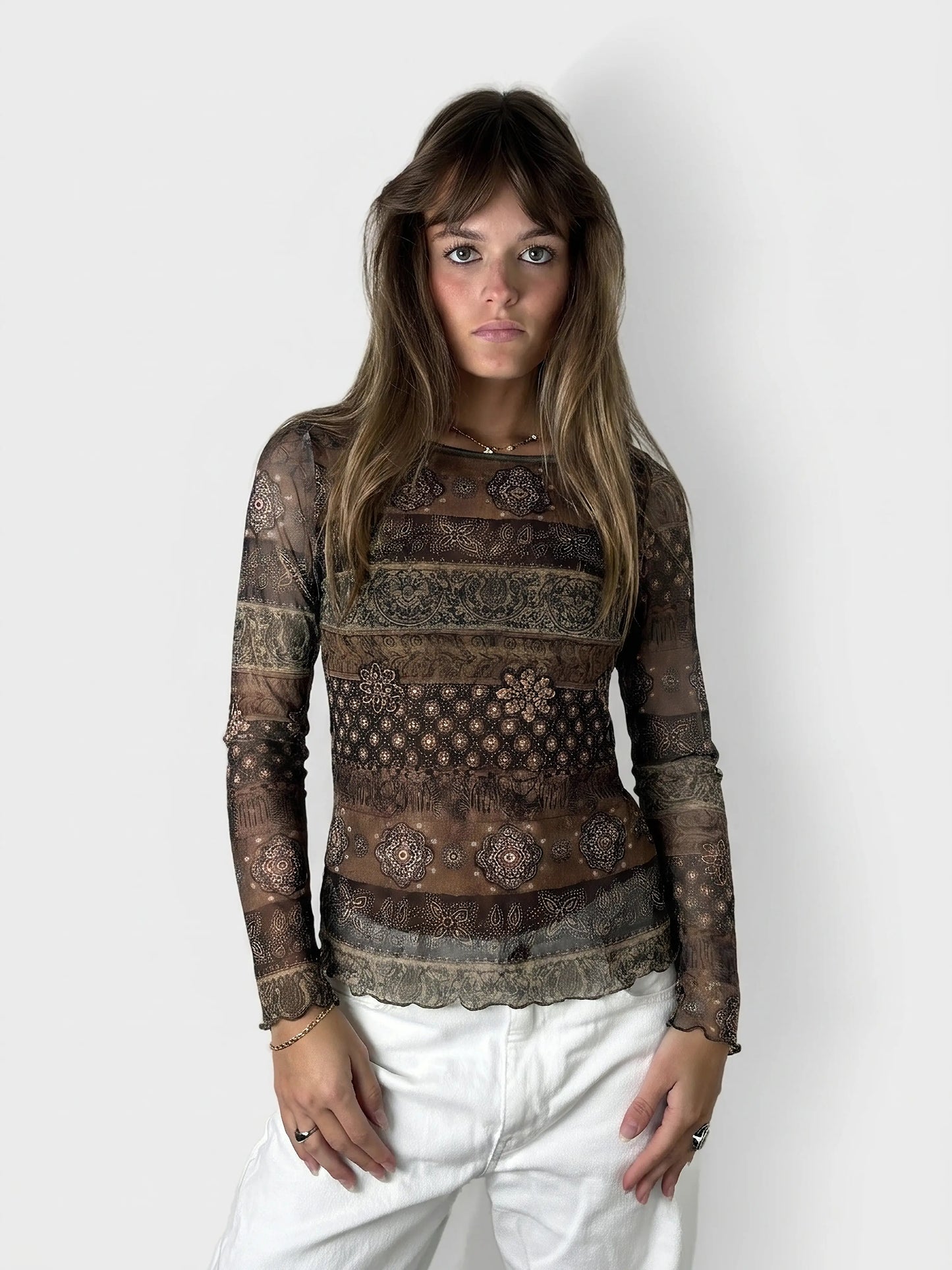 Front view of a brown body shirt featuring intricate floral patterns.