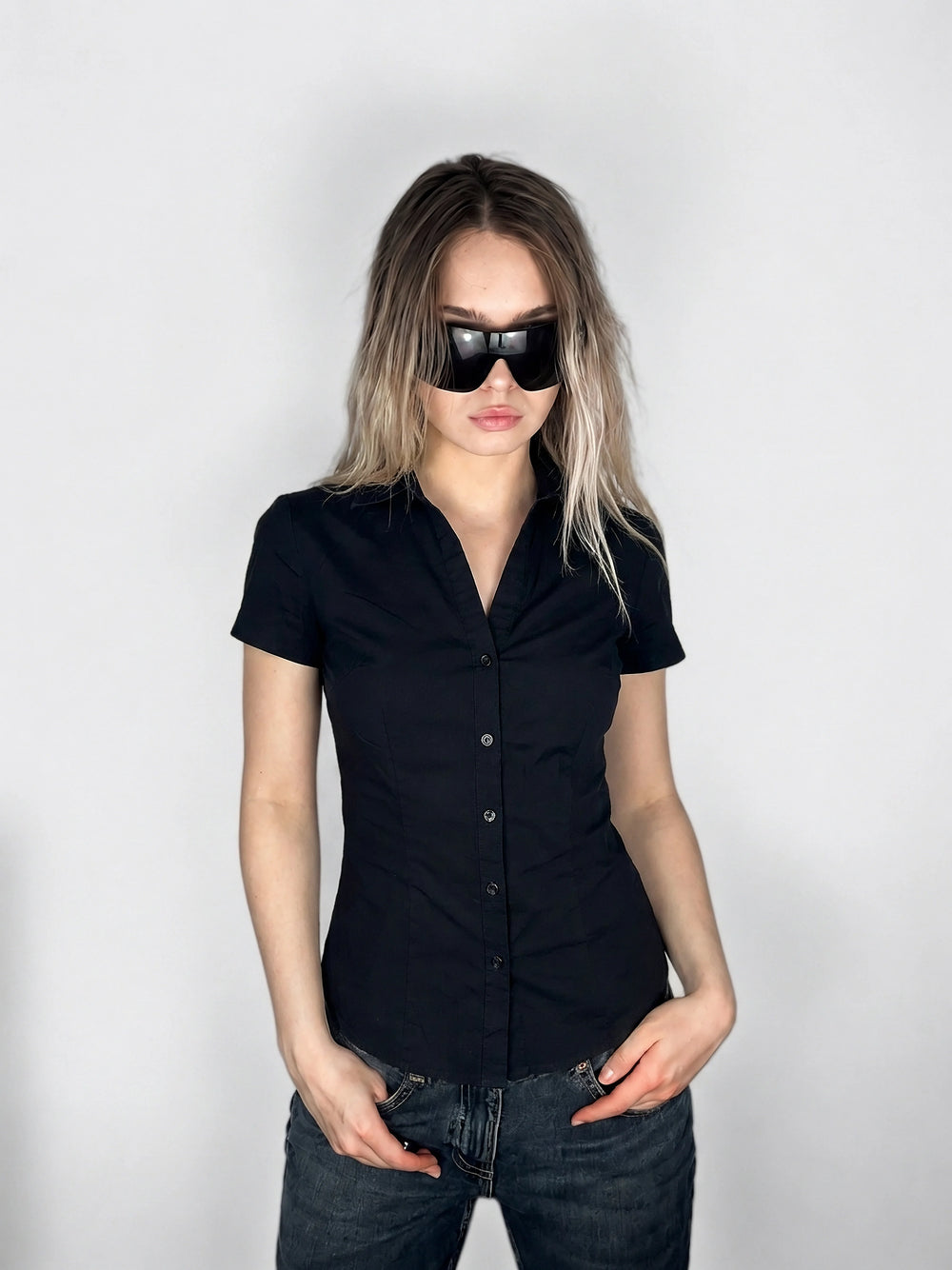 Black body shirt featuring a button-down front view.