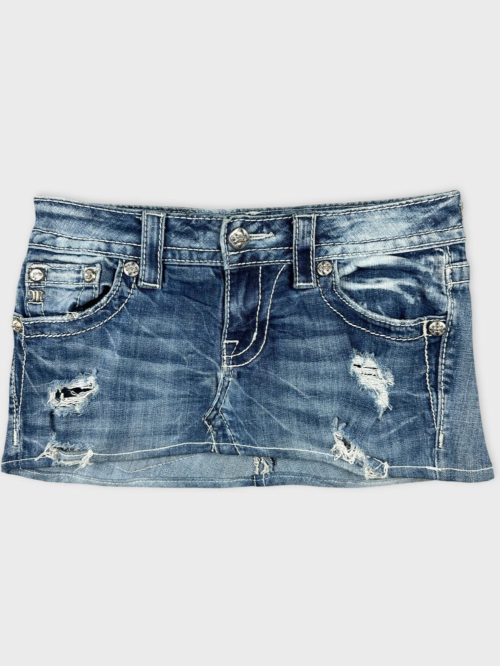 Front view of blue distressed denim body shorts with silver button detailing.