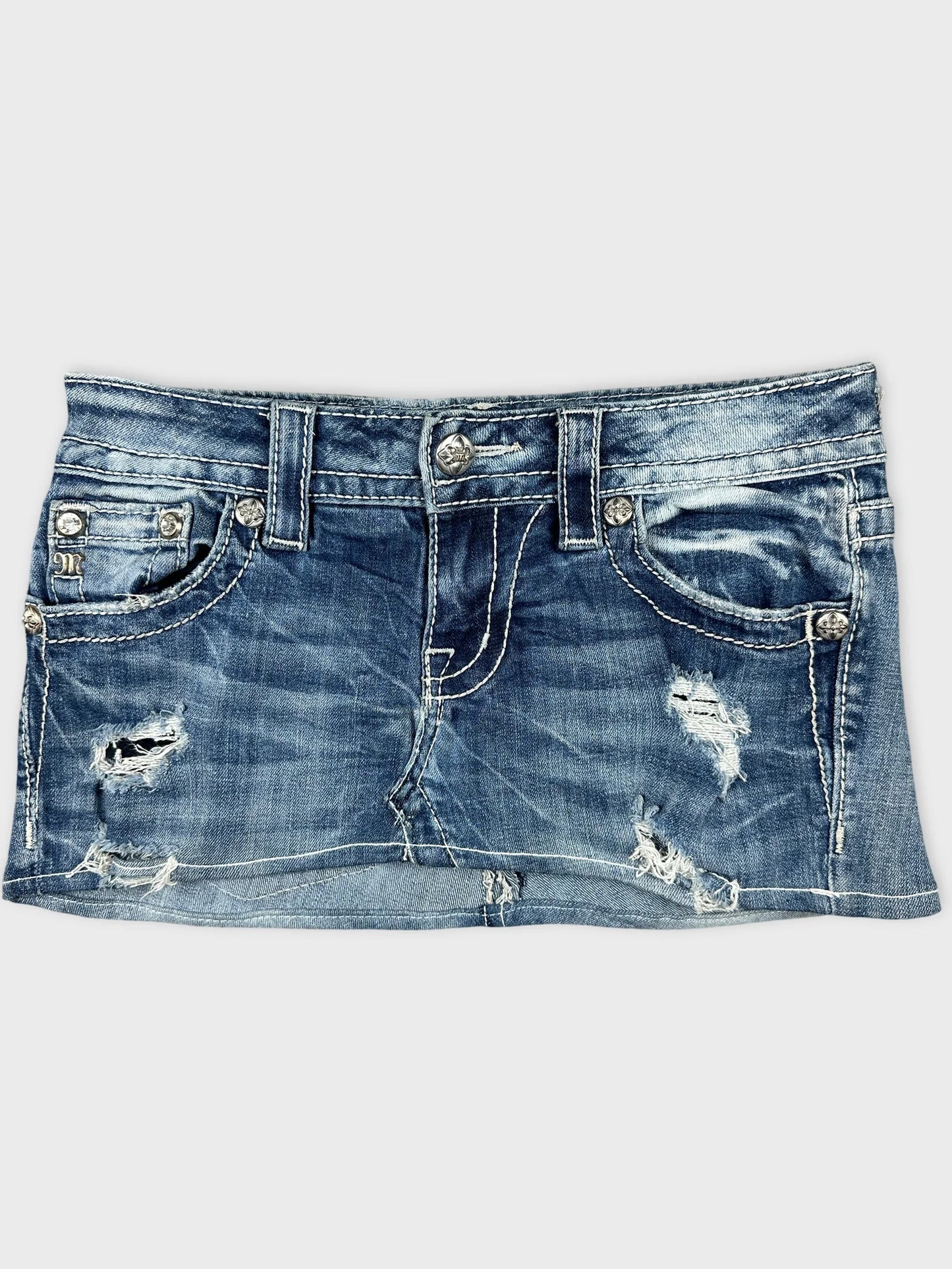 Front view of blue distressed denim body shorts with silver button detailing.