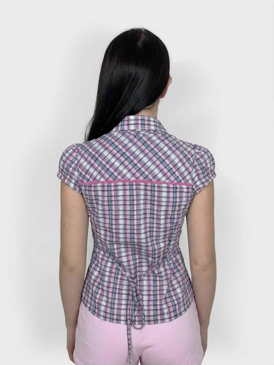 Back view of a women's plaid T-shirt in pink and blue with a tie detail.