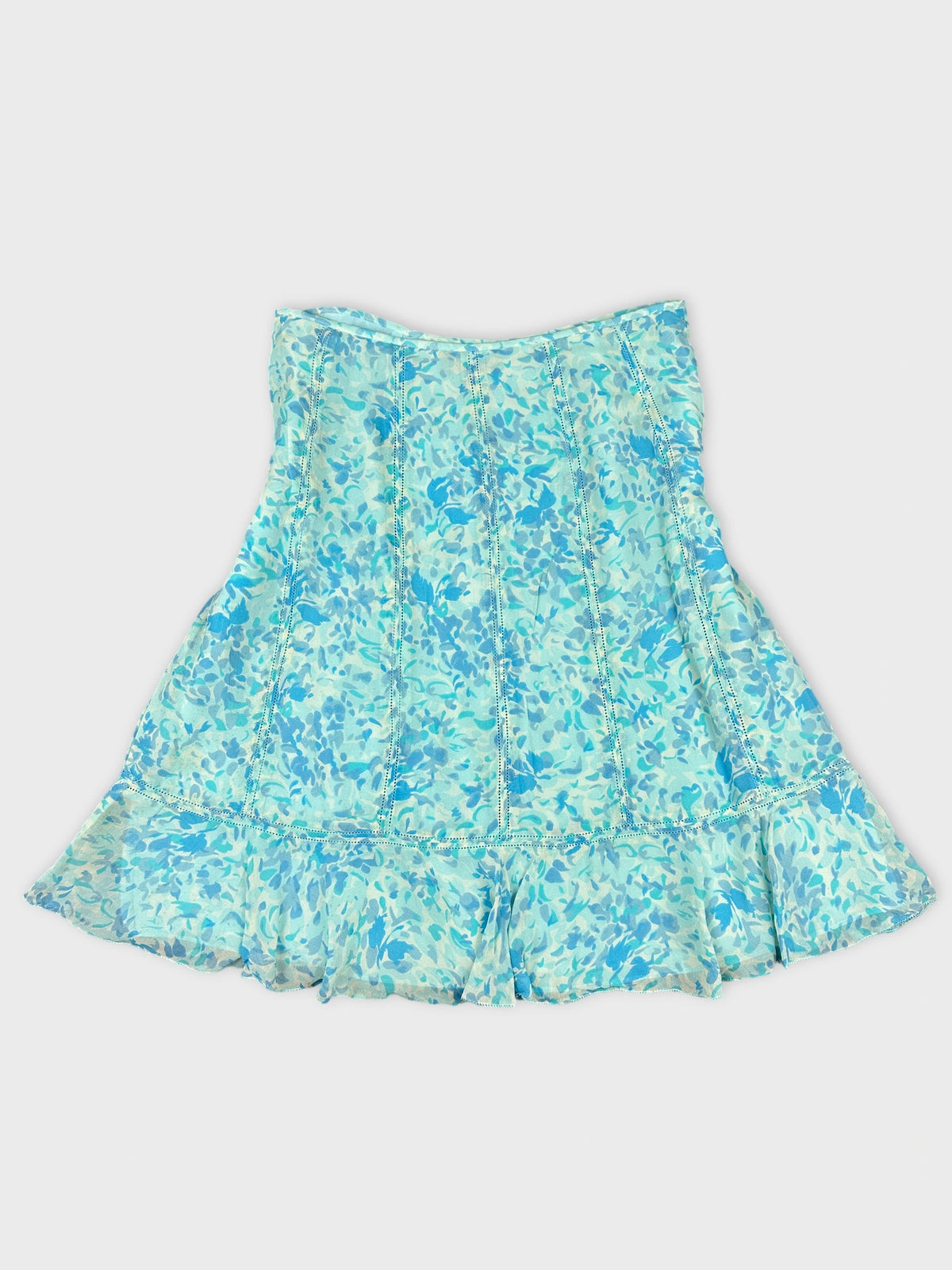 Back view of a blue floral print dress with ruffled hem.