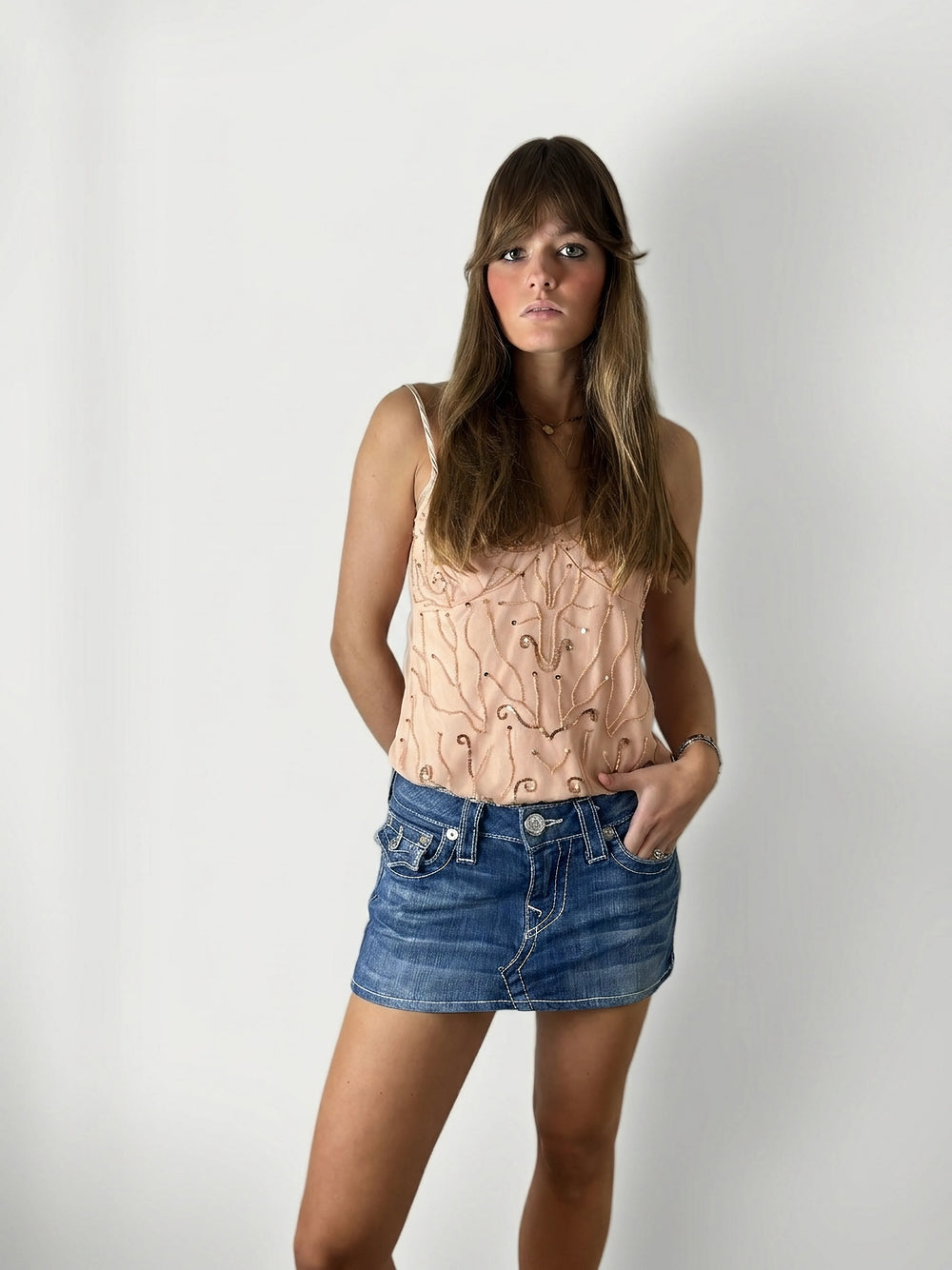Front view of a denim skirt in blue with visible stitching details.