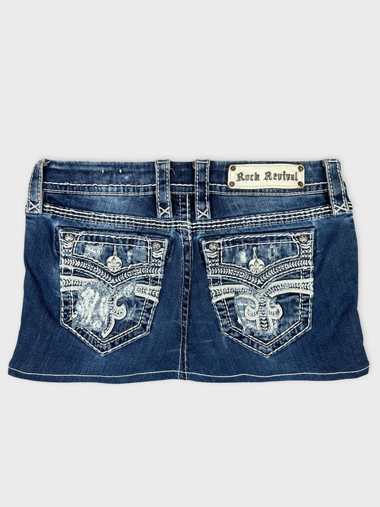 Back view of denim mini skirt featuring intricate embroidered pockets.