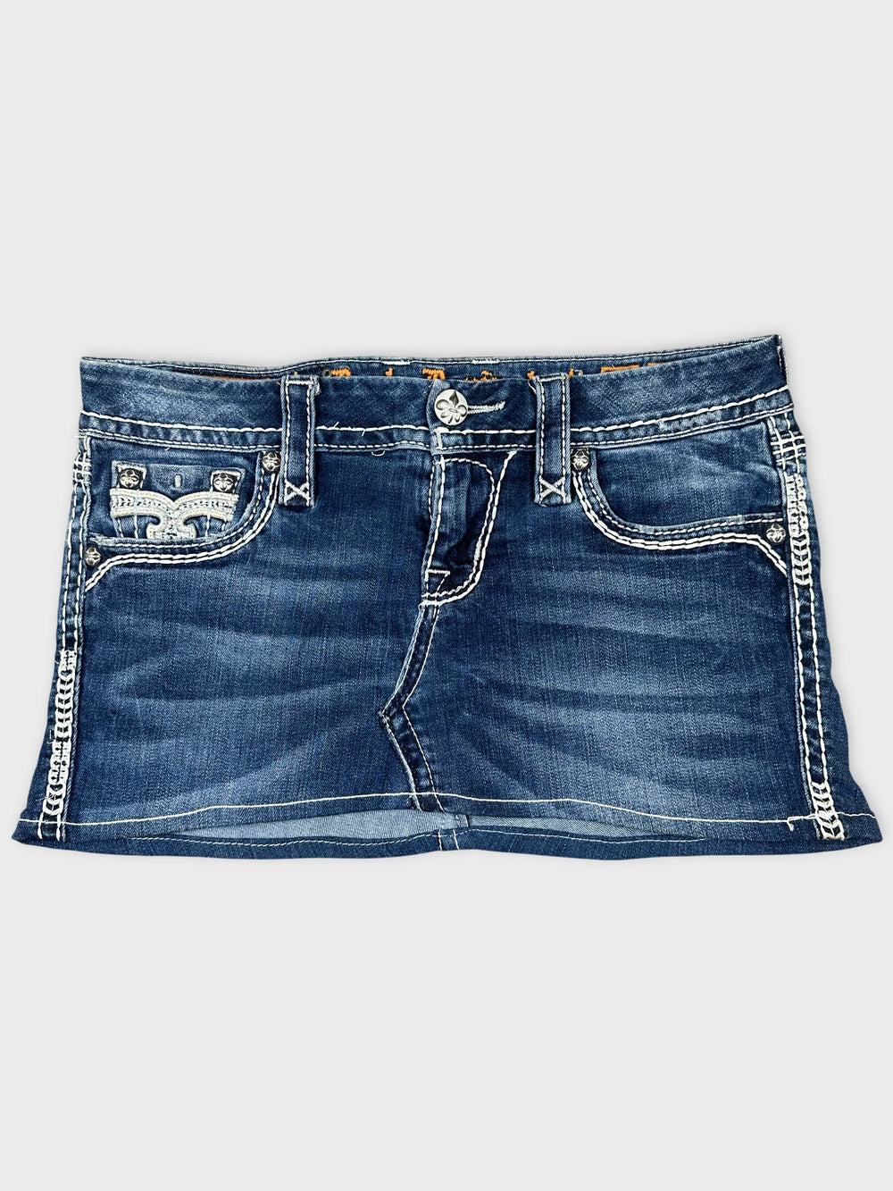 Front view of a blue denim mini skirt featuring decorative stitching details.