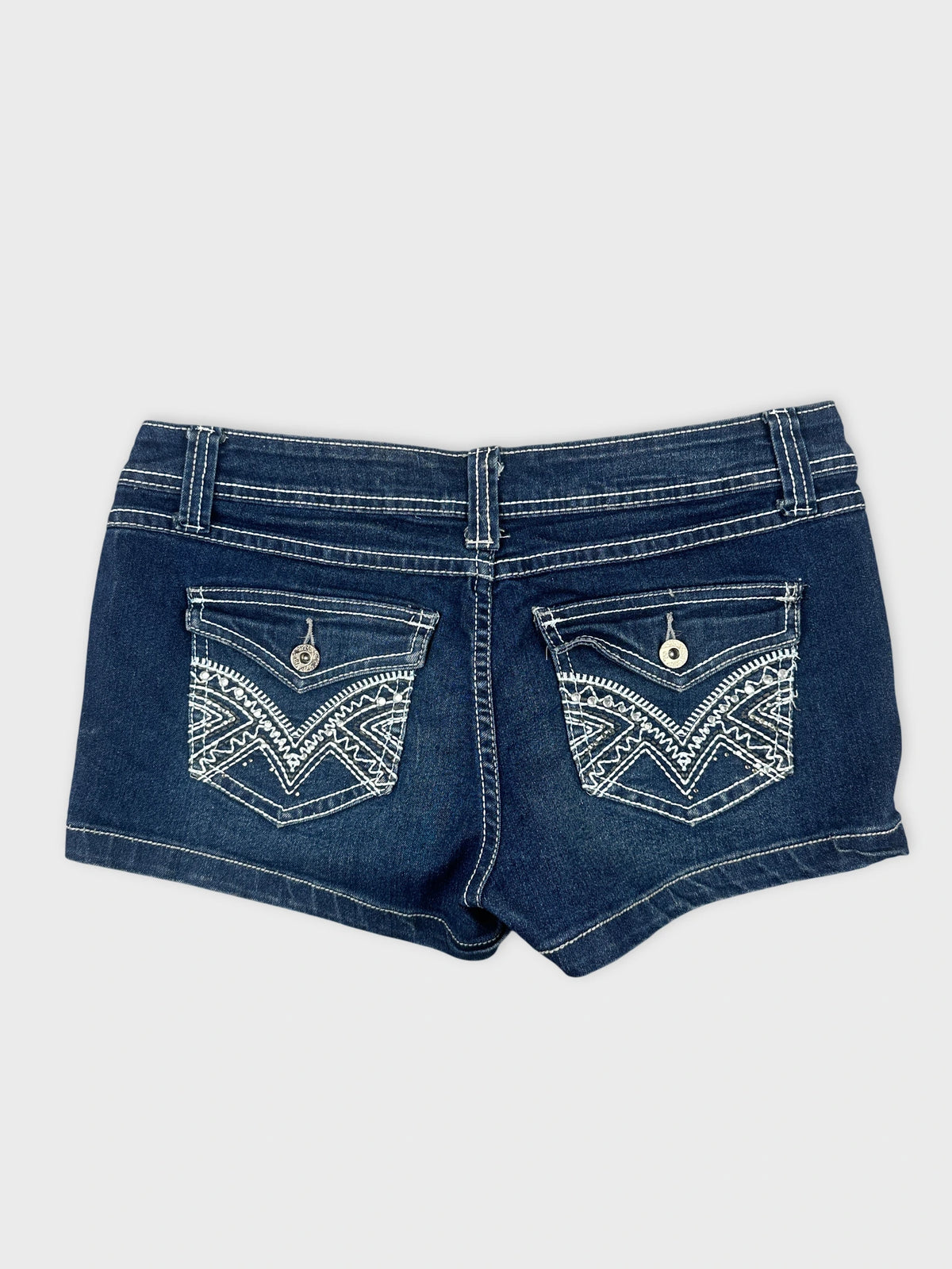 Back view of denim shorts in dark blue with embroidered pockets.