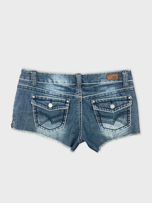 Back view of denim shorts featuring a faded blue color and decorative stitching.